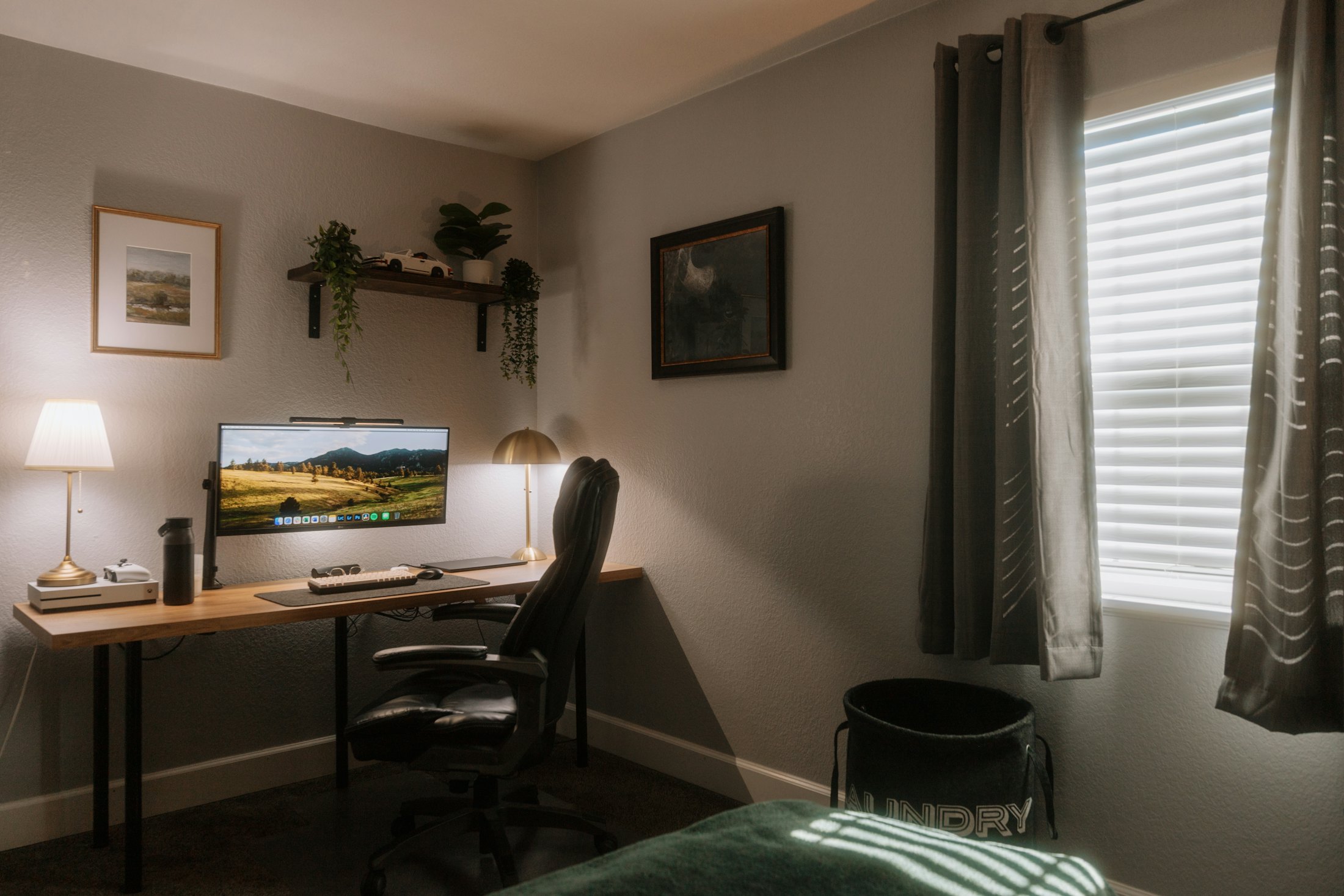 A warm, cozy home office with a desk, computer, and soft natural light
